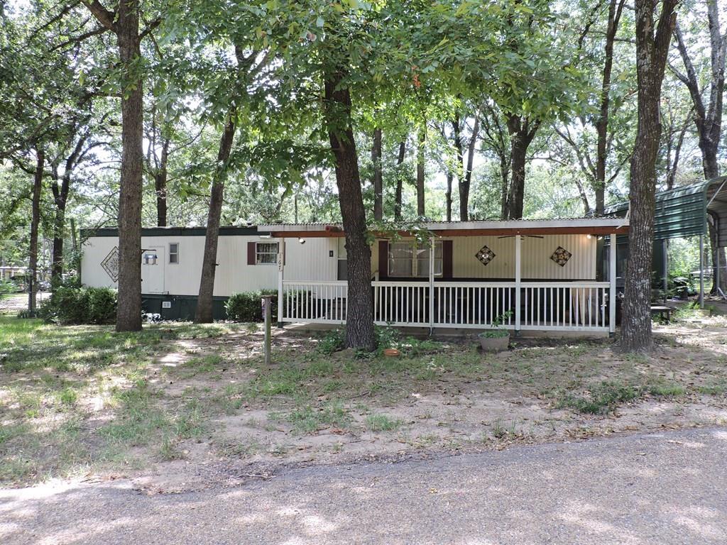 167 Bay Drive Mabank, TX 75156 - Photo 5 of 11 a view of a small yard and large trees