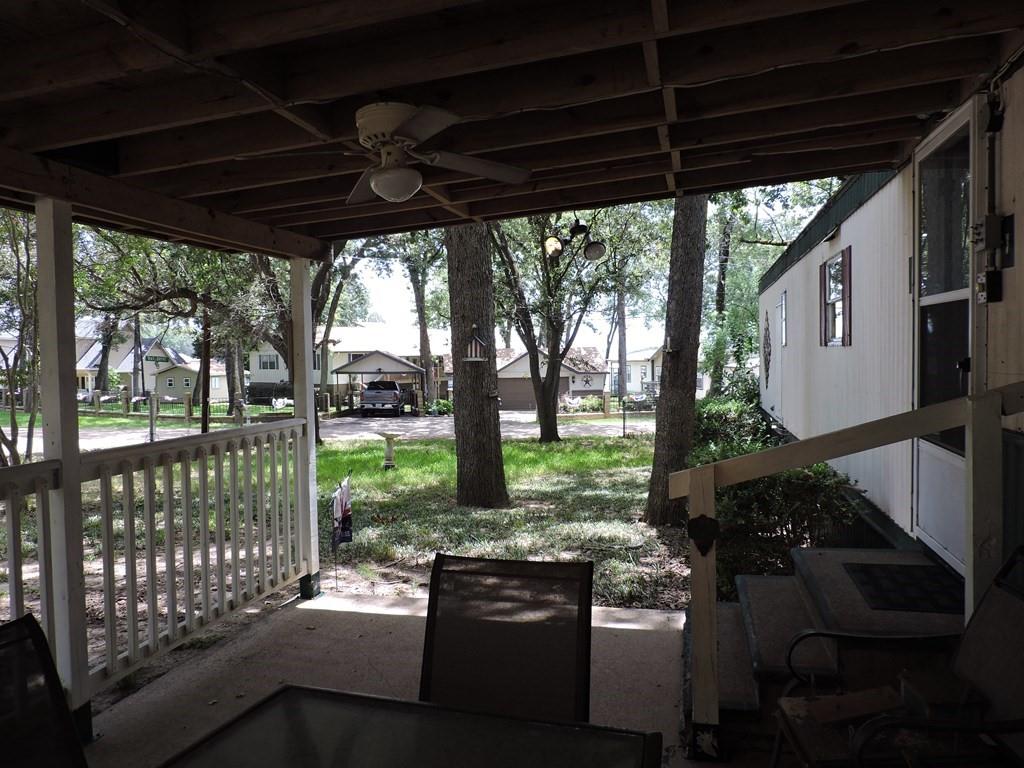 167 Bay Drive Mabank, TX 75156 - Photo 7 of 11 a view of a porch with furniture and a yard