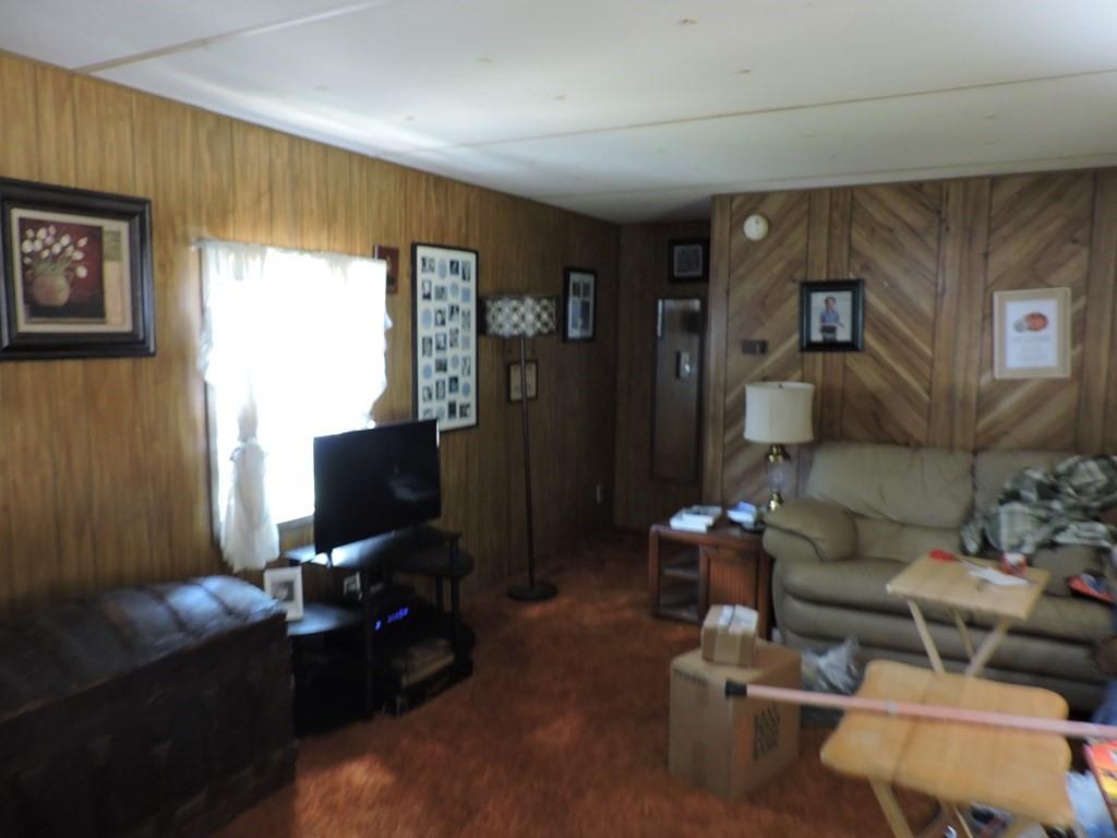167 Bay Drive Mabank, TX 75156 - Photo 9 of 11 a living room with furniture and a flat screen tv