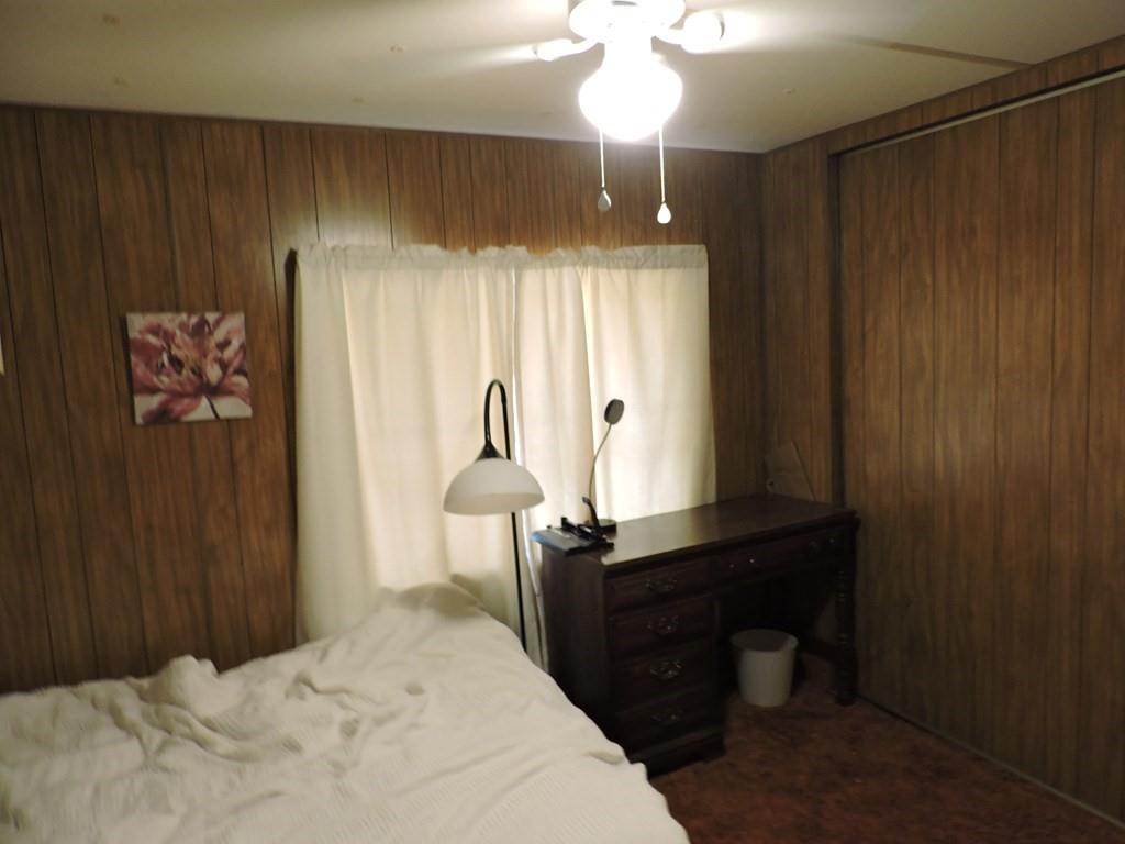 167 Bay Drive Mabank, TX 75156 - Photo 10 of 11 a bedroom with a bed and a chandelier