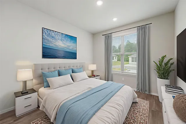 a bedroom with a bed and a lamp on table