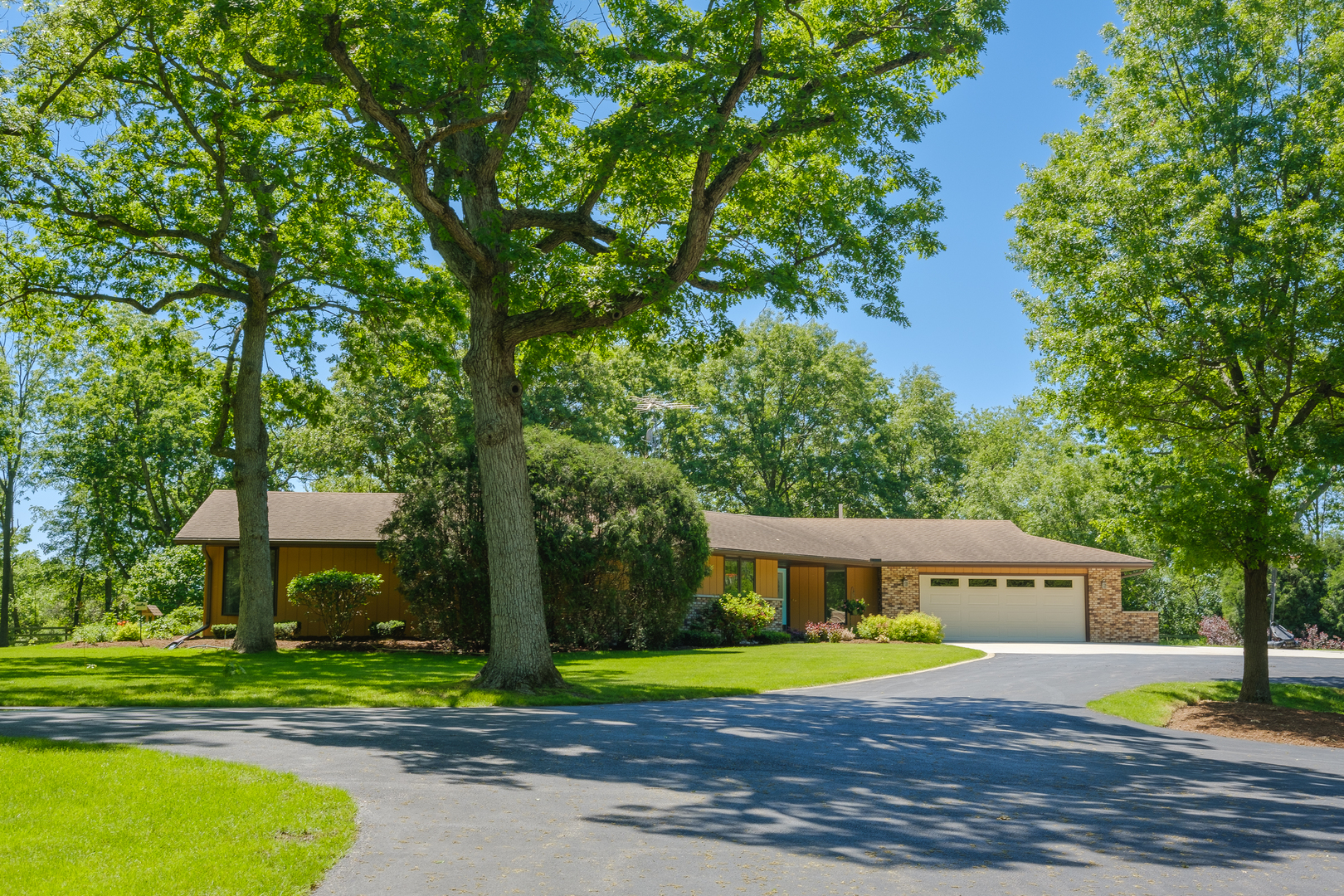 7405 Maxon Road Harvard, IL 60033 - Photo 3 of 30 a front view of a house with a yard and large trees