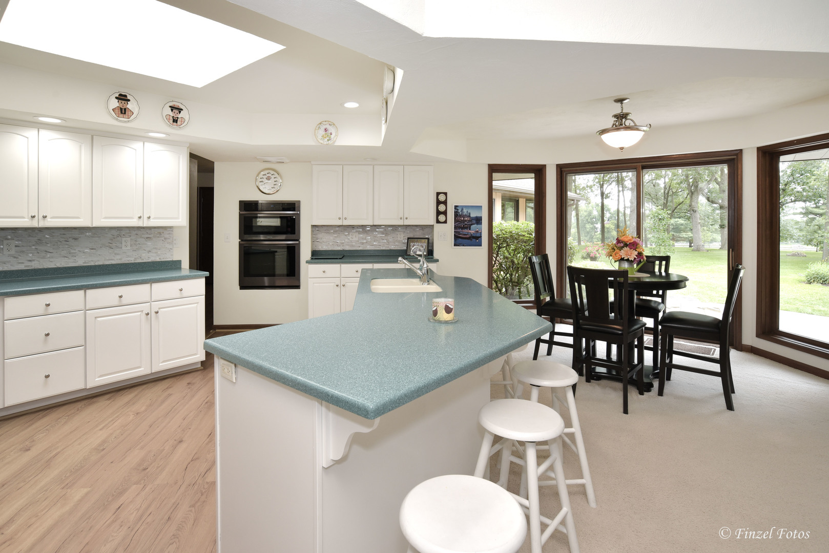 7405 Maxon Road Harvard, IL 60033 - Photo 9 of 30 a kitchen with stainless steel appliances granite countertop a stove a refrigerator a kitchen island a table and chairs