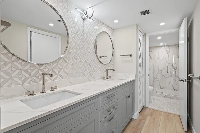 a bathroom with a shower and a glass door