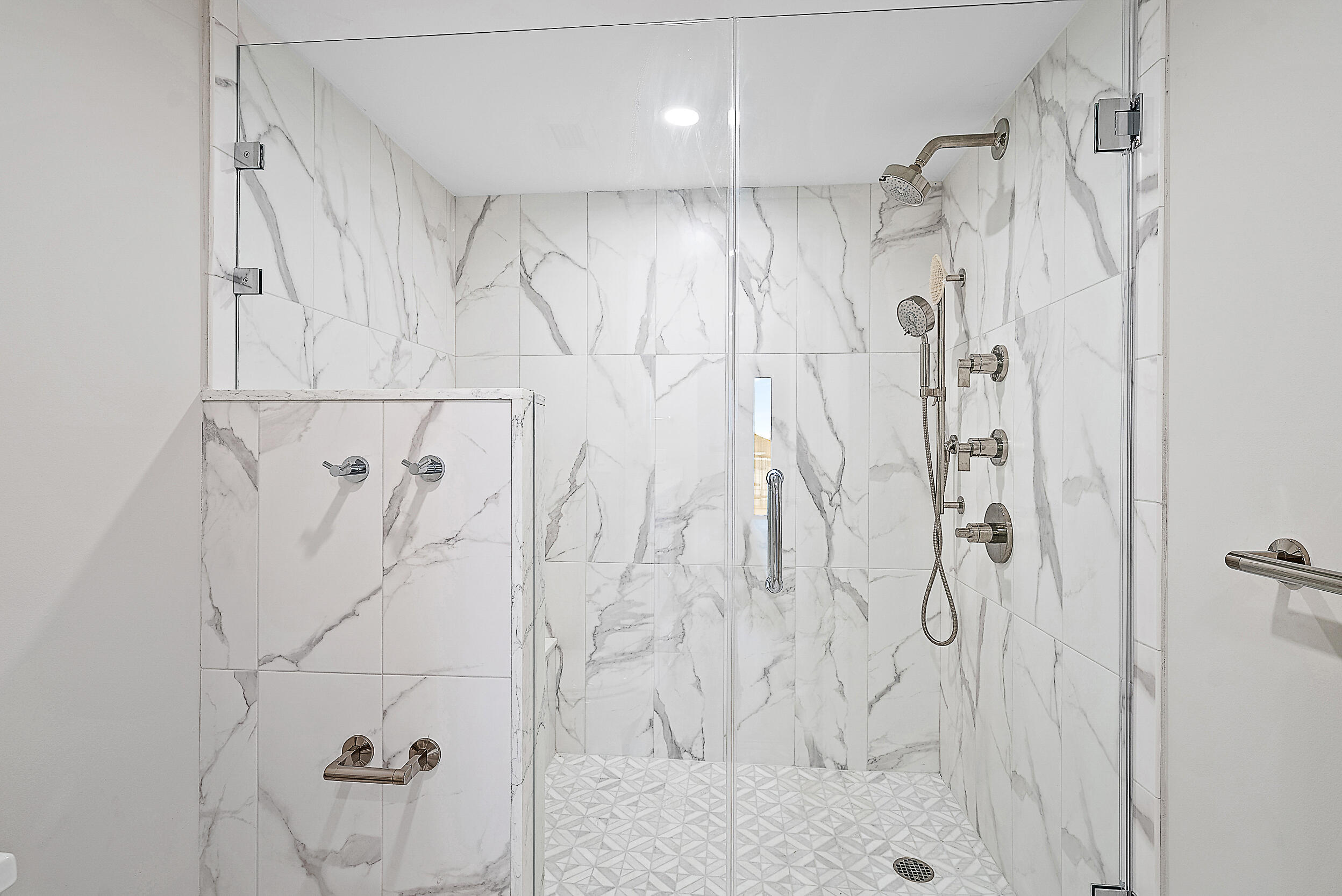 16910 Bay Street, Unit E204 Jupiter, FL 33477 - Photo 7 of 27 a bathroom with a shower and a glass door