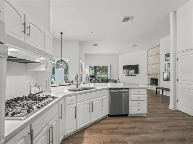 a kitchen with stainless steel appliances a refrigerator sink and cabinets