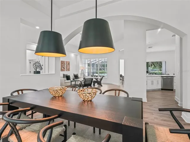 a kitchen with kitchen island granite countertop a table and chairs in it