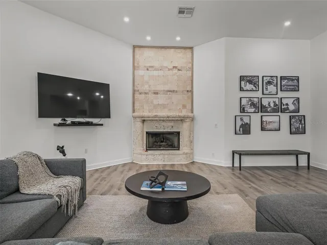 a spacious bedroom with a bed a dresser and a window