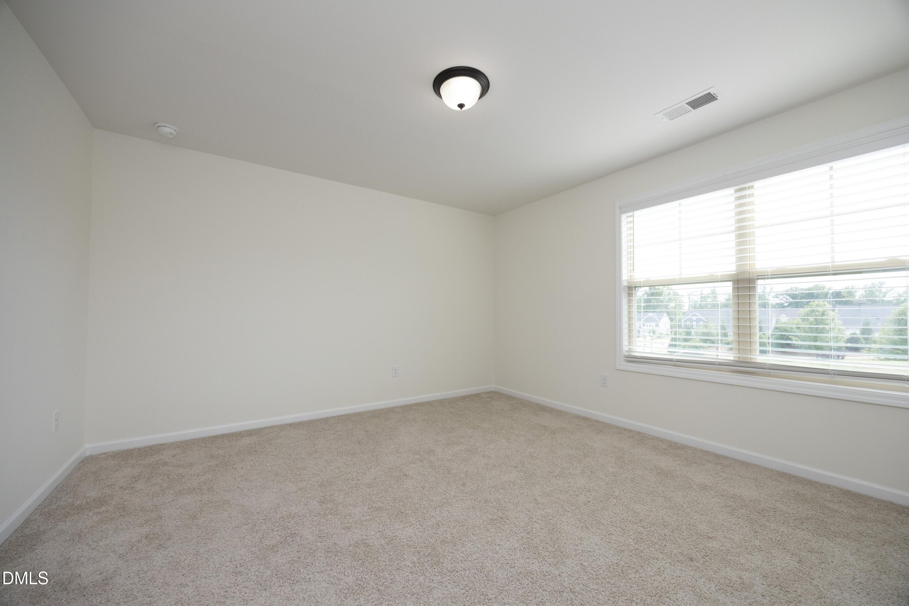 824 Country Downs Road Wake Forest, NC 27587 - Photo 28 of 41 an empty room with a window