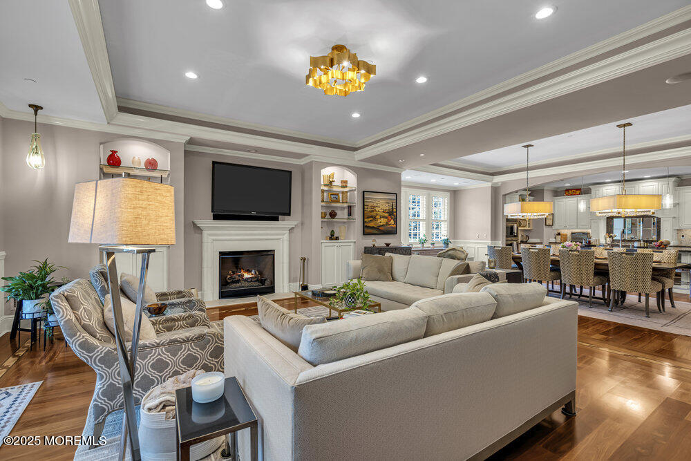 1222 Oval Road Manasquan, NJ 08736 - Photo 16 of 77 a living room with furniture a fireplace and a flat screen tv
