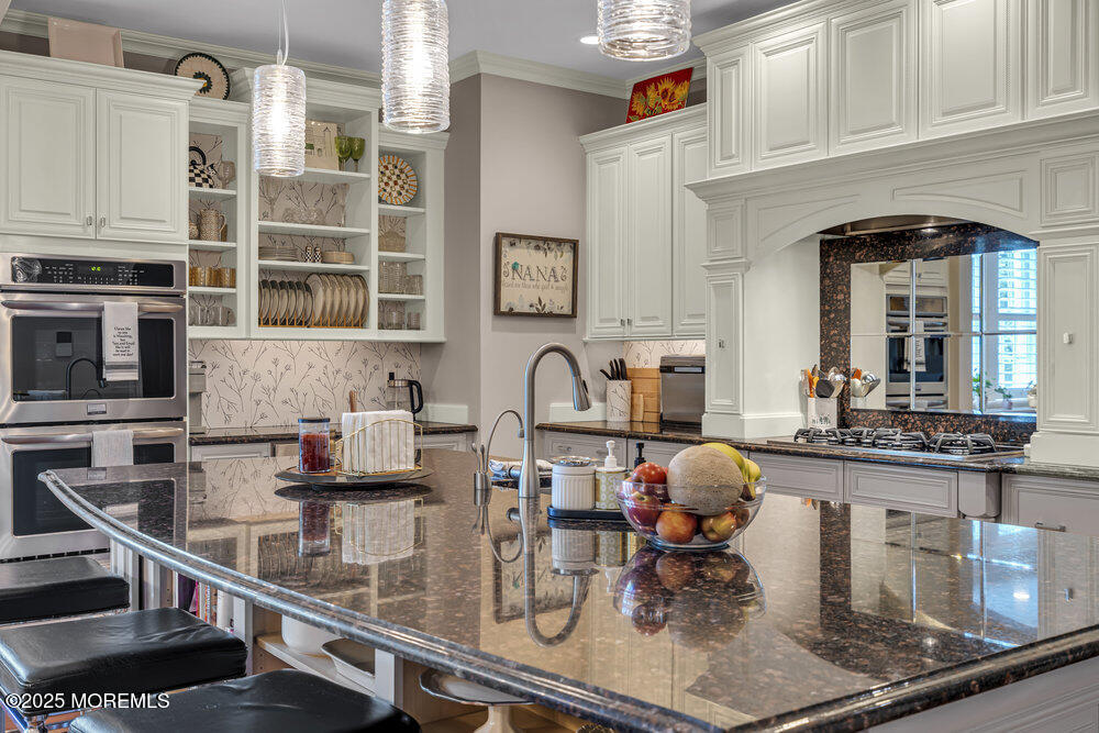 1222 Oval Road Manasquan, NJ 08736 - Photo 29 of 77 a kitchen with stainless steel appliances granite countertop a stove and cabinets
