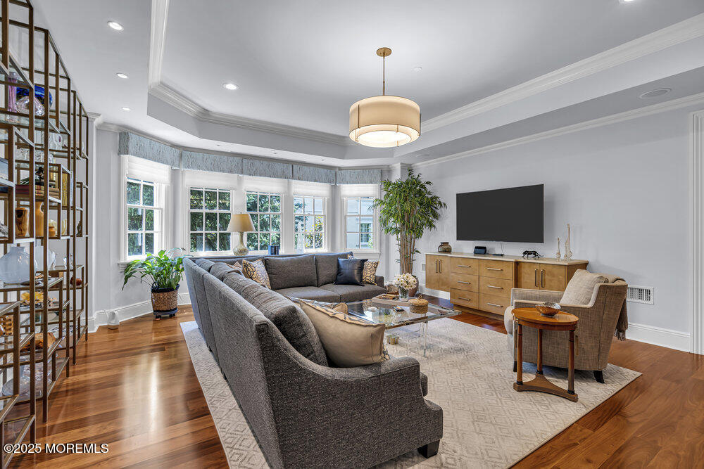 1222 Oval Road Manasquan, NJ 08736 - Photo 33 of 77 a living room with furniture flat screen tv and a large window