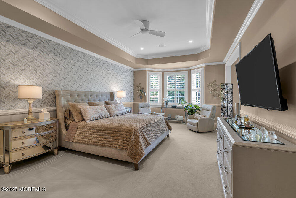 1222 Oval Road Manasquan, NJ 08736 - Photo 39 of 77 a bedroom with a bed and flat screen tv