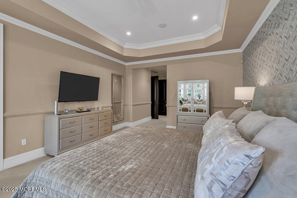 1222 Oval Road Manasquan, NJ 08736 - Photo 41 of 77 a bedroom with a large bed and a flat screen tv