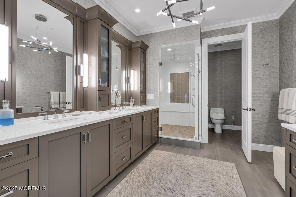 1222 Oval Road Manasquan, NJ 08736 - Photo 48 of 77 a spacious bathroom with a double vanity sink a large mirror and a shower