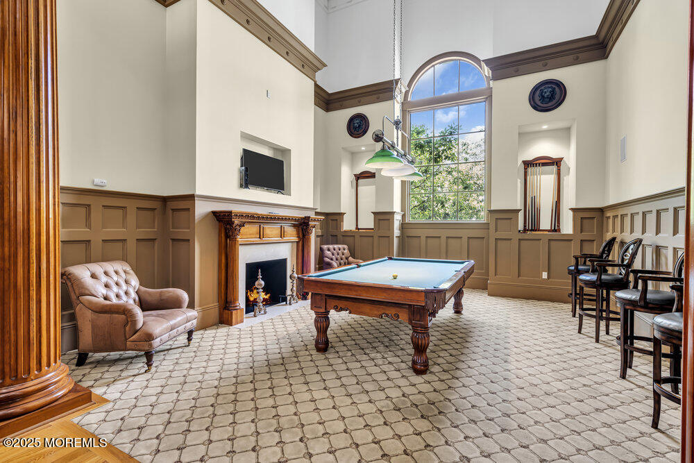 1222 Oval Road Manasquan, NJ 08736 - Photo 73 of 77 a living room with furniture a fireplace and next to a window
