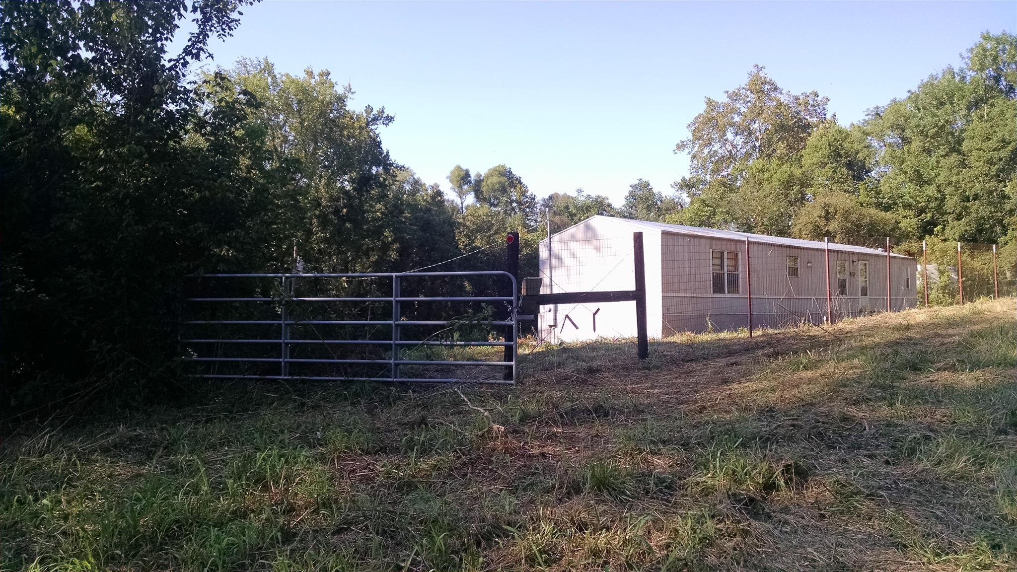 1535 Maddox Road Centerville, TN 37033 - Photo 2 of 26 a view of backyard with wooden fence and trees