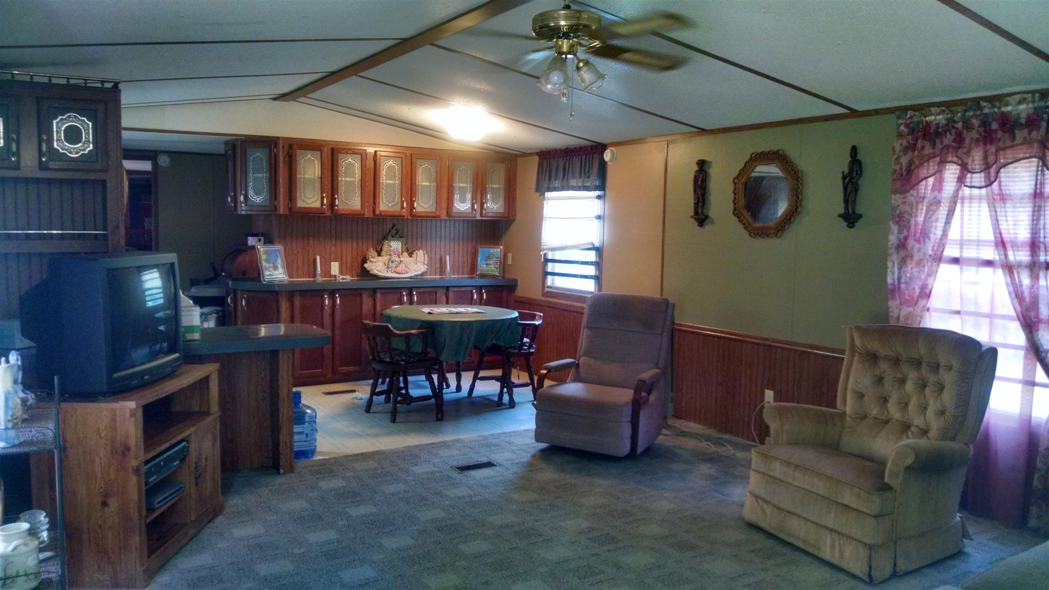 1535 Maddox Road Centerville, TN 37033 - Photo 4 of 26 a living room with furniture a dining table and a bookshelf