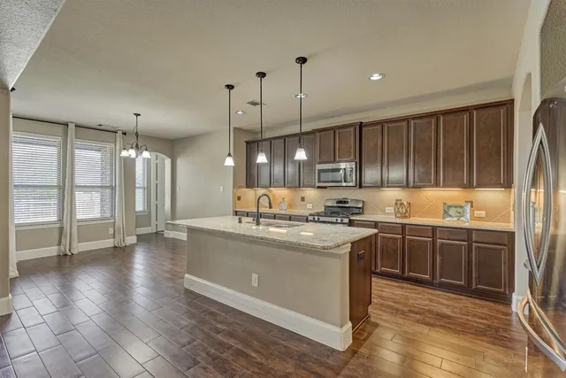 a kitchen with stainless steel appliances granite countertop a stove and a sink