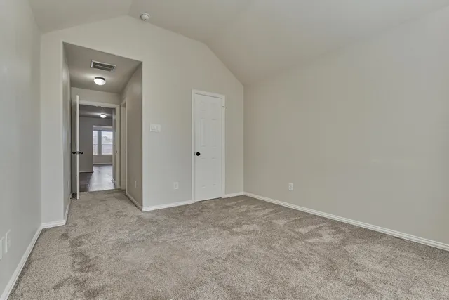 an empty room with closet area