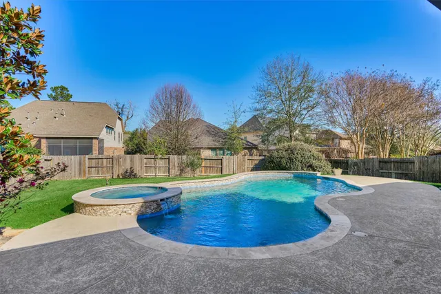 a view of a swimming pool with a yard
