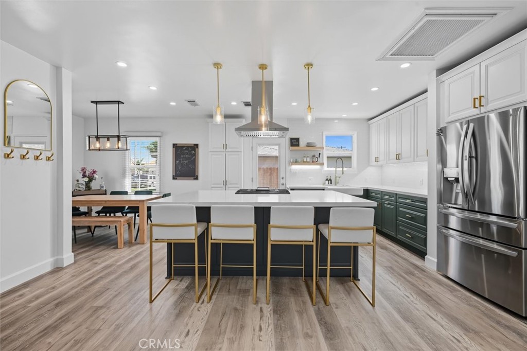 a kitchen with kitchen island wooden cabinets and stainless steel appliances