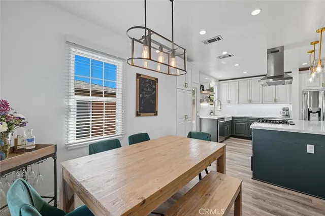 a kitchen with stainless steel appliances granite countertop a stove a sink dishwasher a microwave oven with cabinets and wooden floor