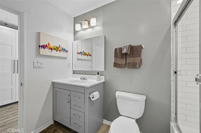 a view of bathroom with a toilet sink and mirror