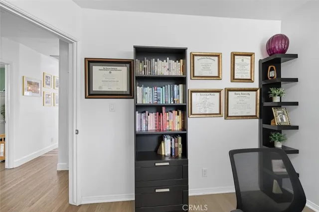 a view of a workspace with furniture and wooden floor
