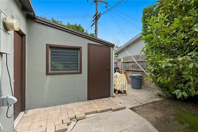 a backyard of a house with table and chairs
