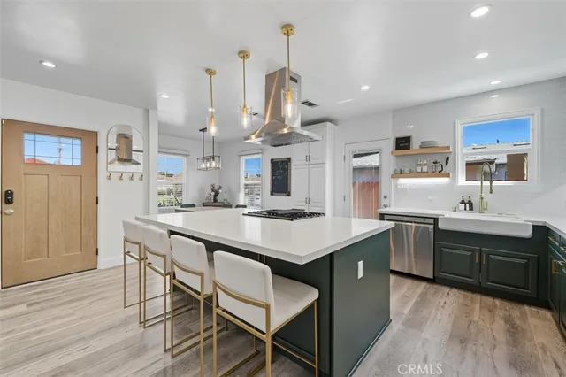 a kitchen with stainless steel appliances kitchen island granite countertop a sink and cabinets