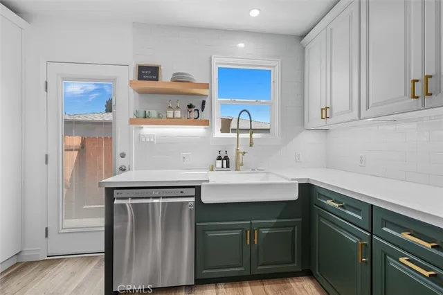 a kitchen with stainless steel appliances granite countertop a sink and cabinets