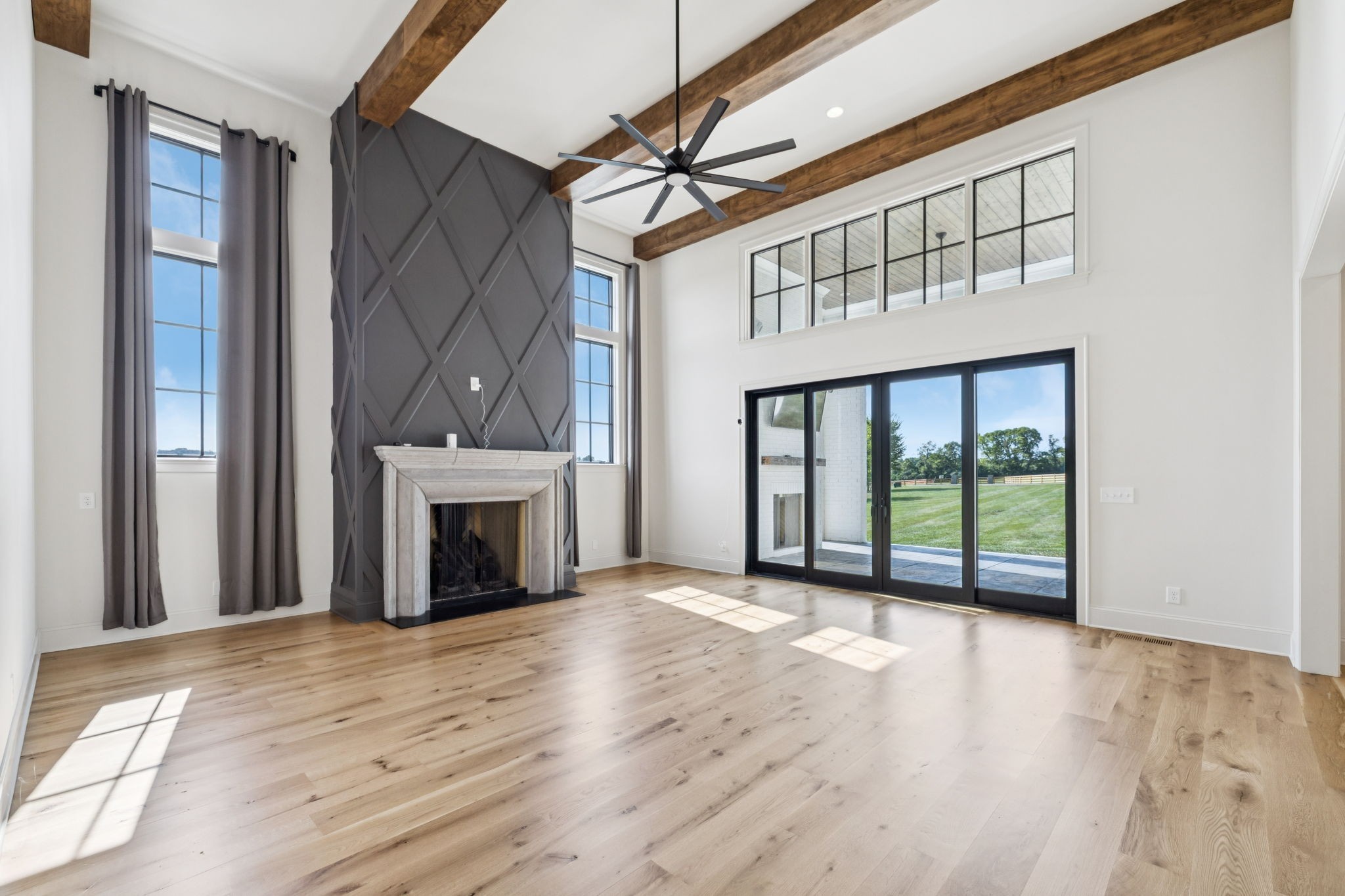 2245 Skinner Road Arrington, TN 37014 - Photo 23 of 98 a view of an empty room with wooden floor fireplace and a window
