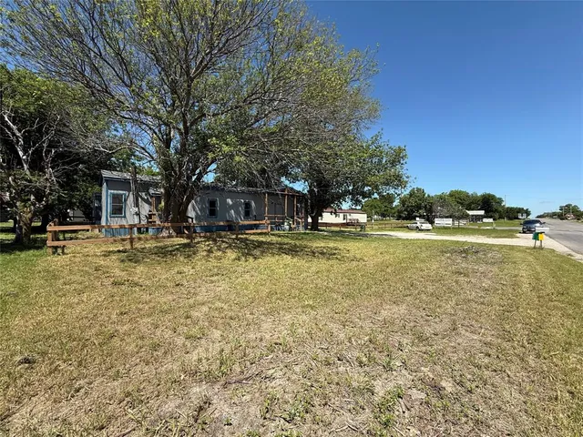 a swimming pool view with tall trees