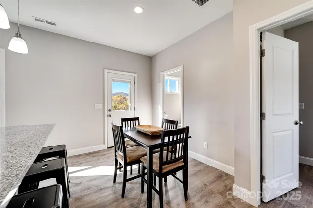 a view of a dining room with furniture and wooden floor