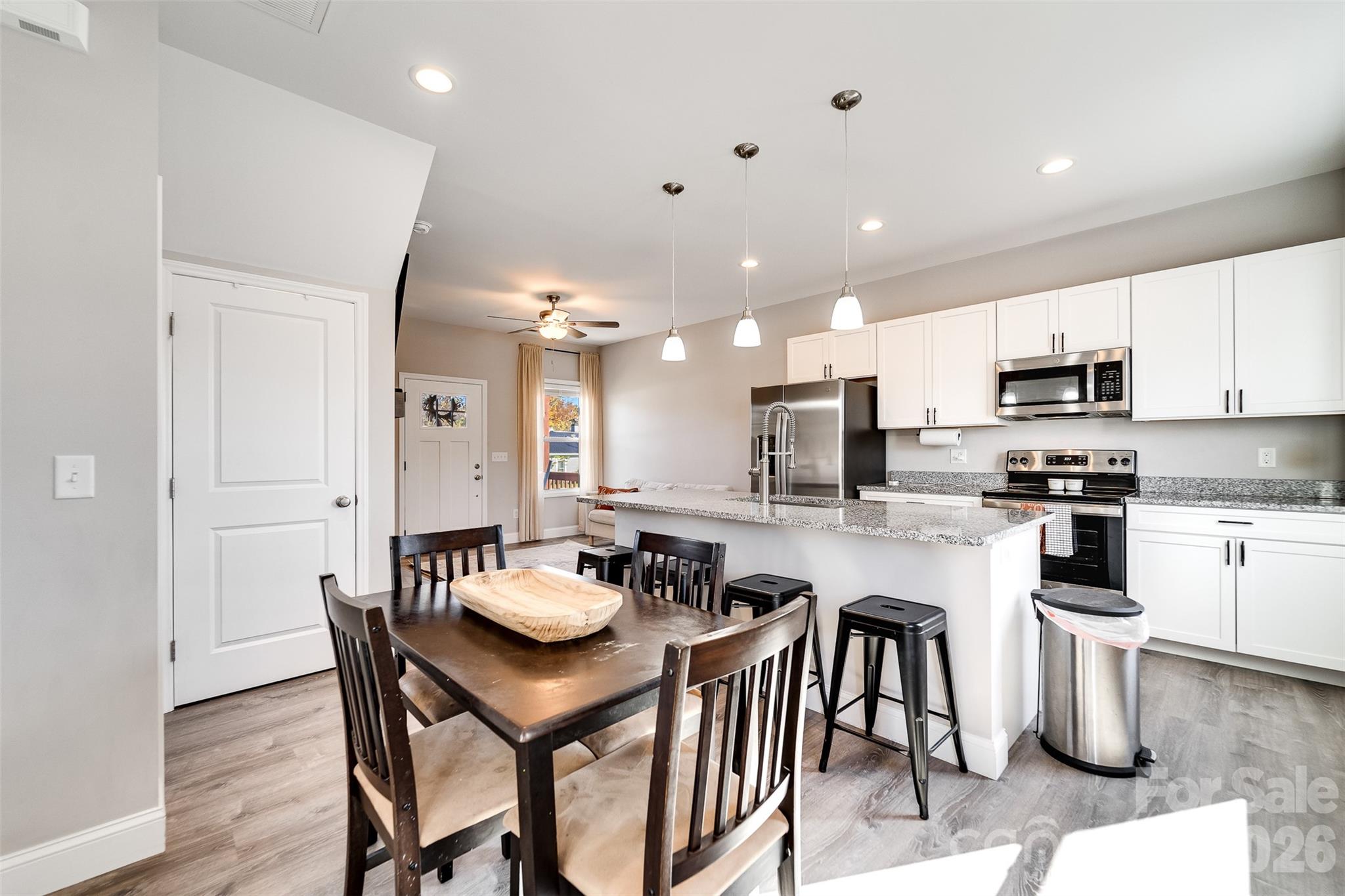 955 North Canton Road Canton, NC 28716 - Photo 12 of 48 a kitchen with a dining table chairs wooden floor appliances and cabinets