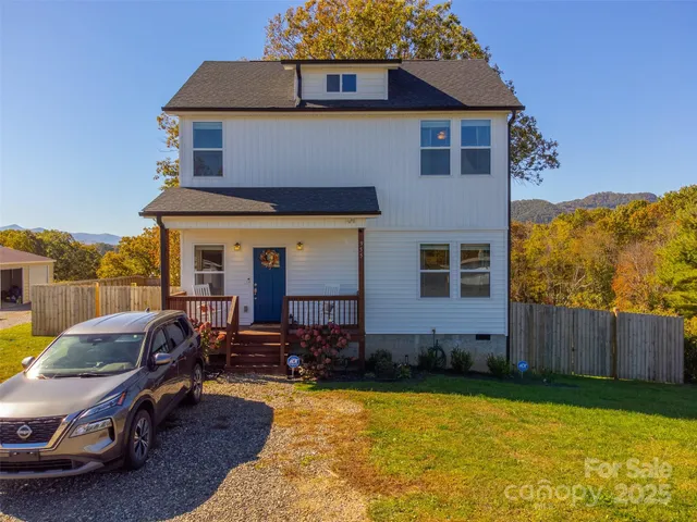 a view of a house with backyard space and sitting area