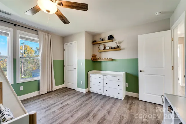 a room with a dresser and a window