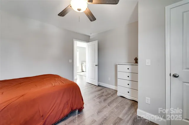 a bedroom with a bed and cabinet