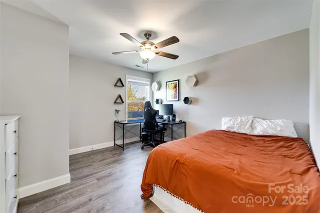 a bed sitting in a bedroom and a chandelier