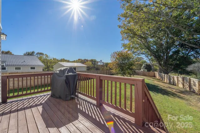 a view of balcony with wooden floor and fence