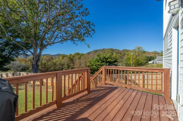 a view of balcony with wooden floor and fence
