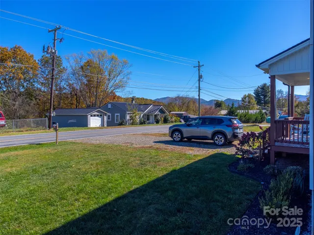 a view of a house with backyard swimming pool and sitting area