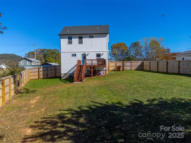 a view of a house with a yard and a garage