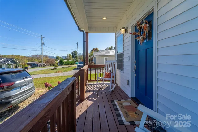 a view of a balcony with wooden floor and iron stairs