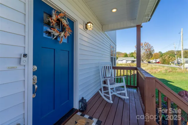 a view of a balcony with chairs and wooden floor