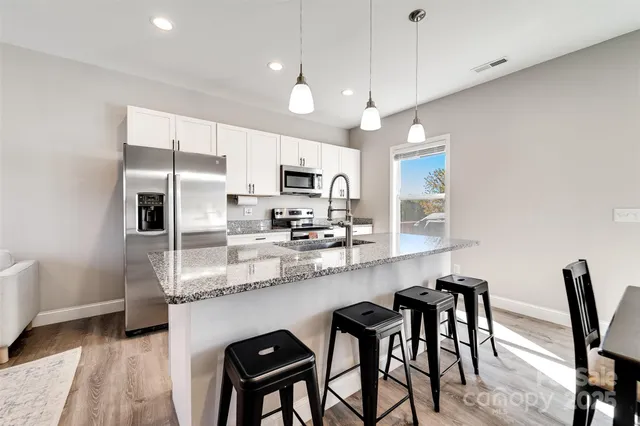 a large kitchen with a table and chairs