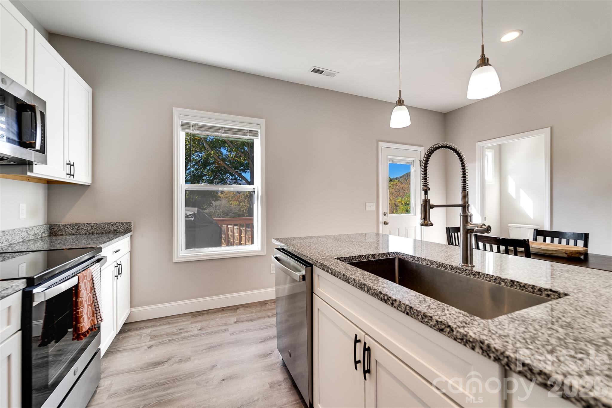 955 North Canton Road Canton, NC 28716 - Photo 9 of 48 a kitchen with granite countertop a sink a counter space appliances and cabinets