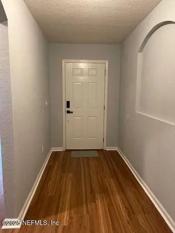 a view of a room with wooden floor and bench