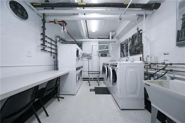a utility room with multiple dryer and washer